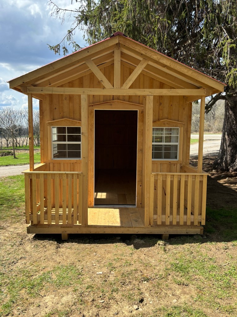 Wooden storage shed with porch